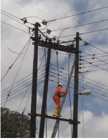Engineer on high tension pole with insulators